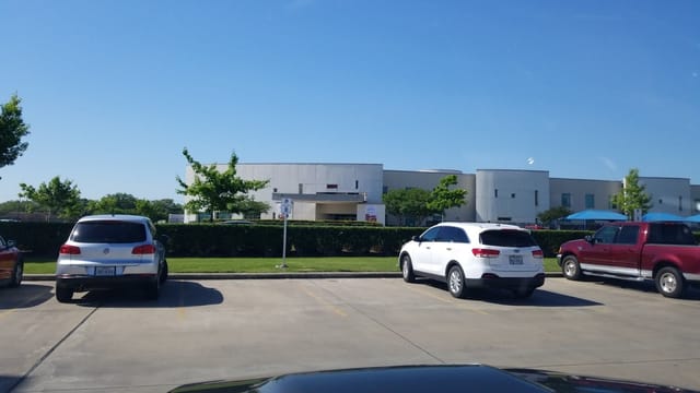 Conference center parking at KBC Houston, spacious and well-landscaped for events.