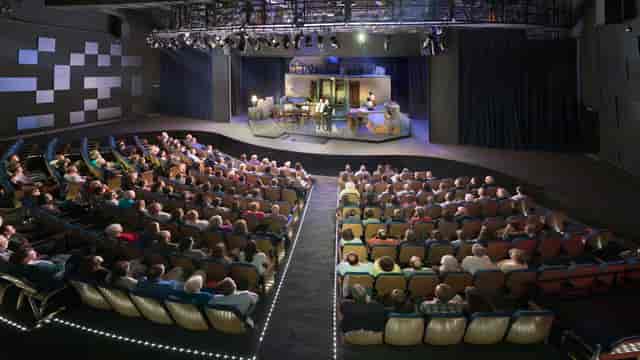 "Performance space at Wortham Center with engaged audience and stage for events and presentations"