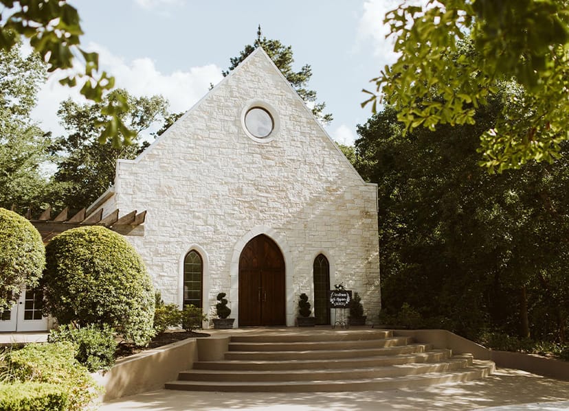Charming stone chapel venue with arched entrance for weddings and gatherings in Houston.