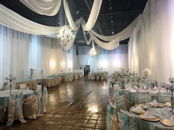 Elegant reception hall in The Gardens Houston, featuring a chandelier for weddings and events.