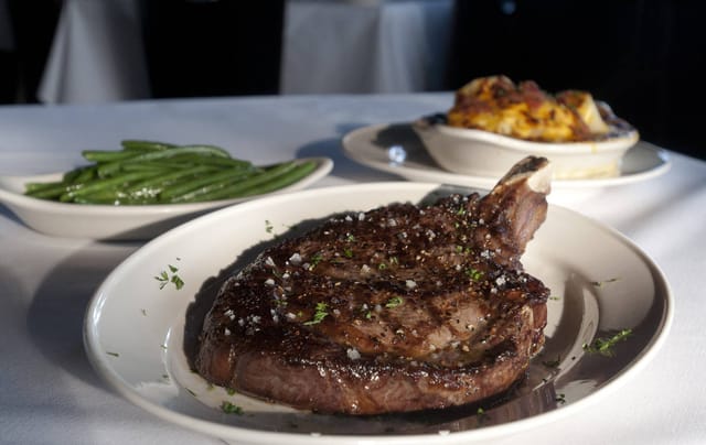 VIP dining experience with perfectly cooked steak at Pappas Bros. Steakhouse event.