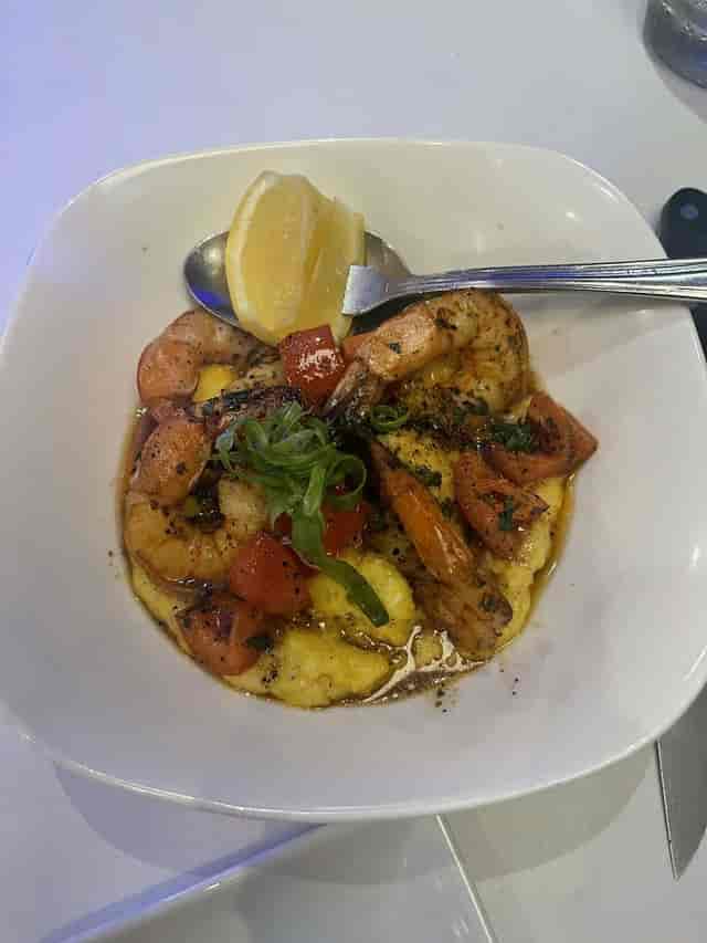 Vibrant shrimp and grits dish at Oceanaire Seafood Room for events and catering.