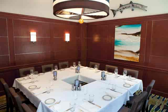 Private dining room with elegant table setup for intimate meetings and upscale events.