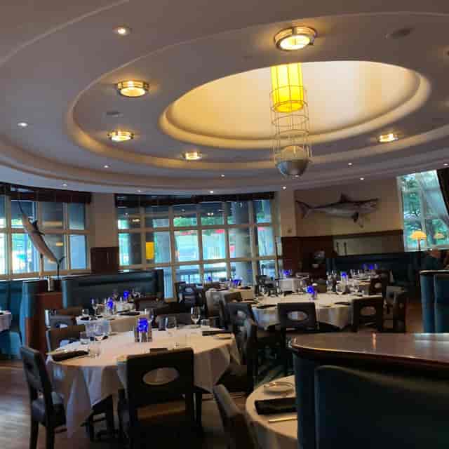 Elegant dining space with blue glassware, perfect for corporate events or gatherings.