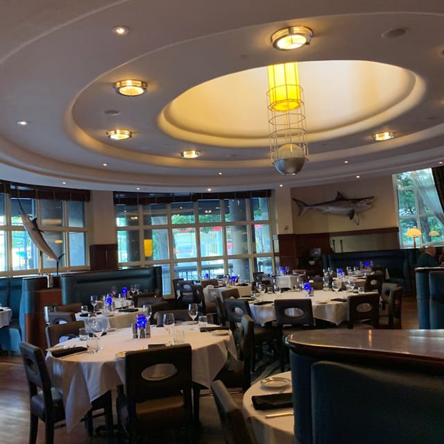 Elegant dining space with blue glassware, perfect for corporate events or gatherings.