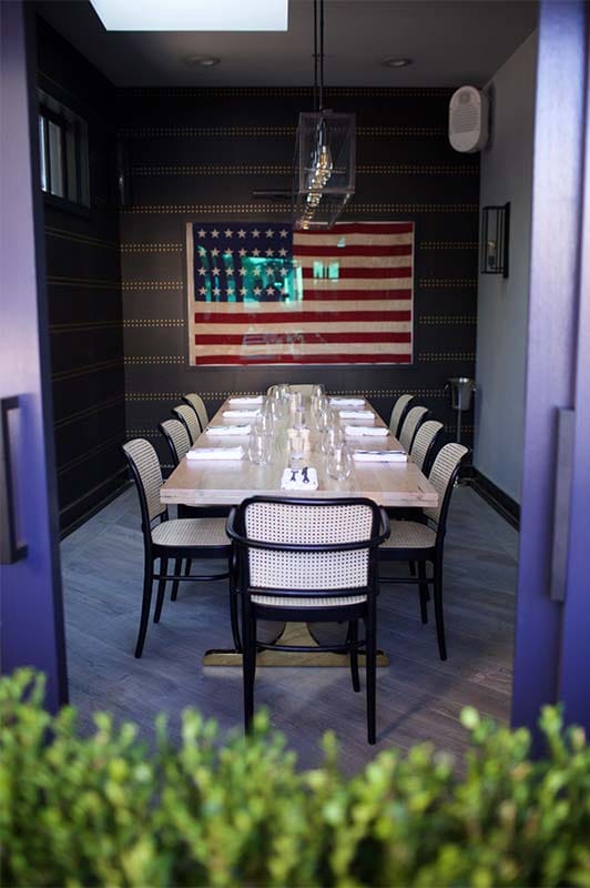 Private dining room with minimalist table, ideal for intimate meetings and gatherings.