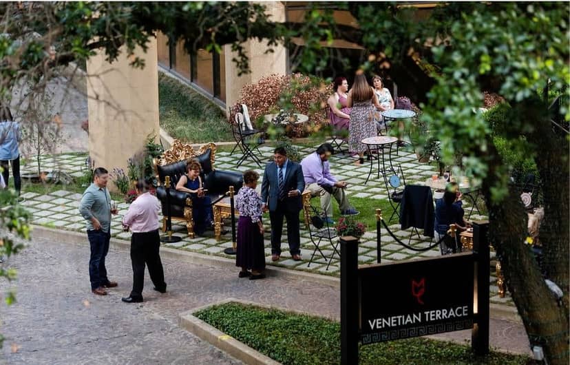 Outdoor networking event at Ceremony Terrace, featuring lush greenery and elegant seating.