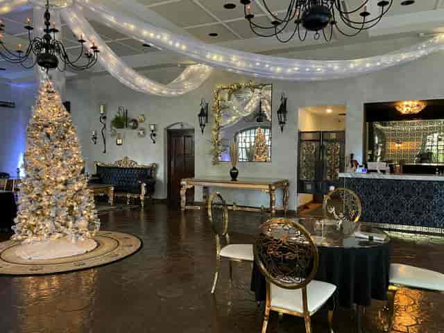 Elegant wedding venue with winter decor and white Christmas tree, perfect for upscale events.
