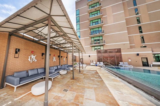 Outdoor infinity pool at The Highland Dallas, perfect for networking events and casual meetings.