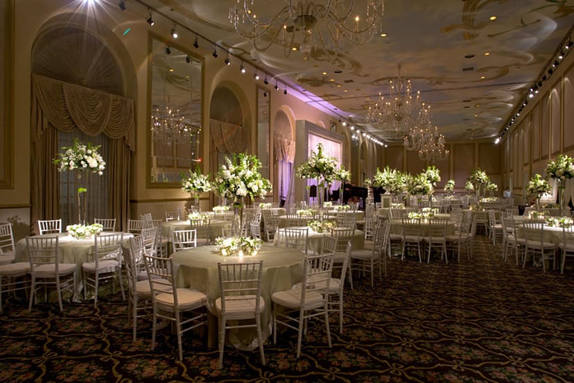 Opus Grand Ballroom, elegant wedding venue with floral centerpieces and luxurious chandeliers.