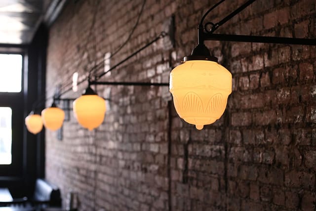 Warm dining area with pendant lighting in Blind Butcher - perfect for gatherings and events.