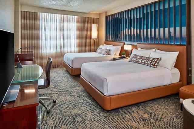Well-appointed hotel room with two beds, ideal for meetings and relaxation in Dallas.