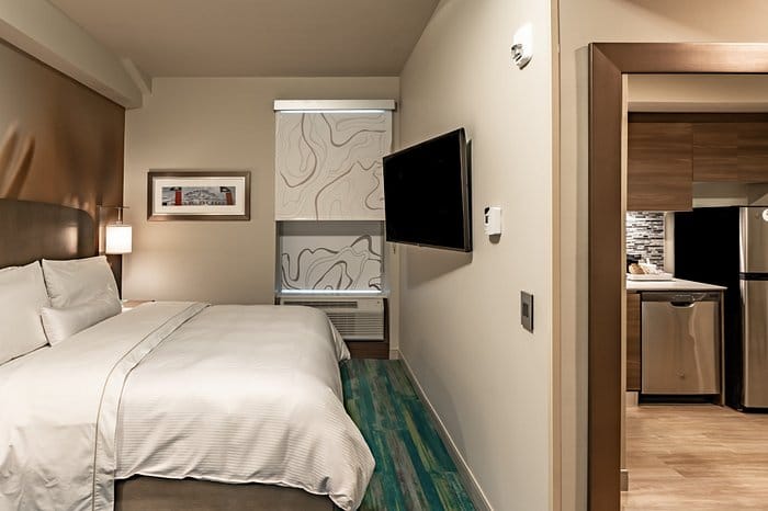 Communal room with kitchenette and sectional couch for business events in Element Dallas.