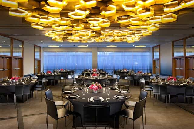 Elegant event space in W Dallas with round tables for receptions and formal dinners.