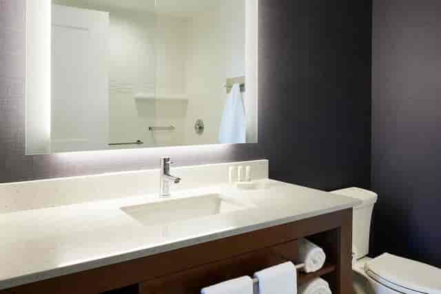 Modern bathroom at Residence Inn Dallas, featuring sleek design and ample counter space for events.