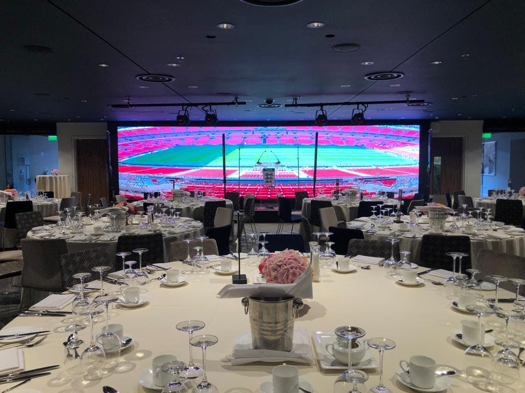 Wembley Suite at Wembley Stadium, elegant dining setup for corporate events.