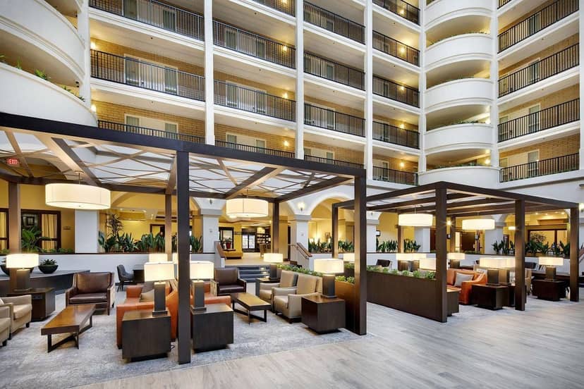 Spacious meeting room atrium at Embassy Suites Dallas for collaboration and networking events.