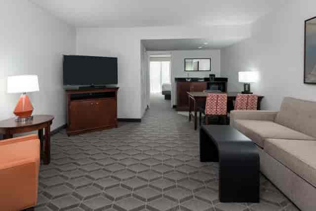 Spacious meeting room in Embassy Suites Dallas with natural light, perfect for events.