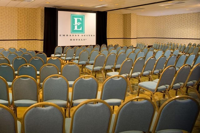 Conference Room at Embassy Suites Dallas, featuring a large projection screen for corporate events.
