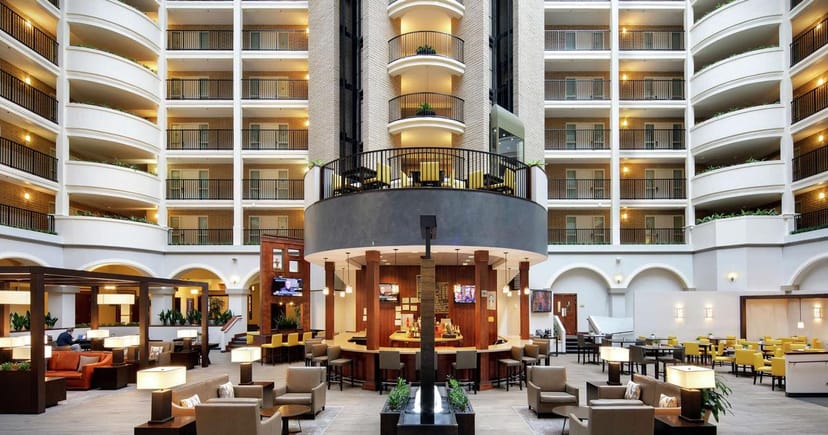 Spacious conference room atrium at Embassy Suites Dallas for networking events.
