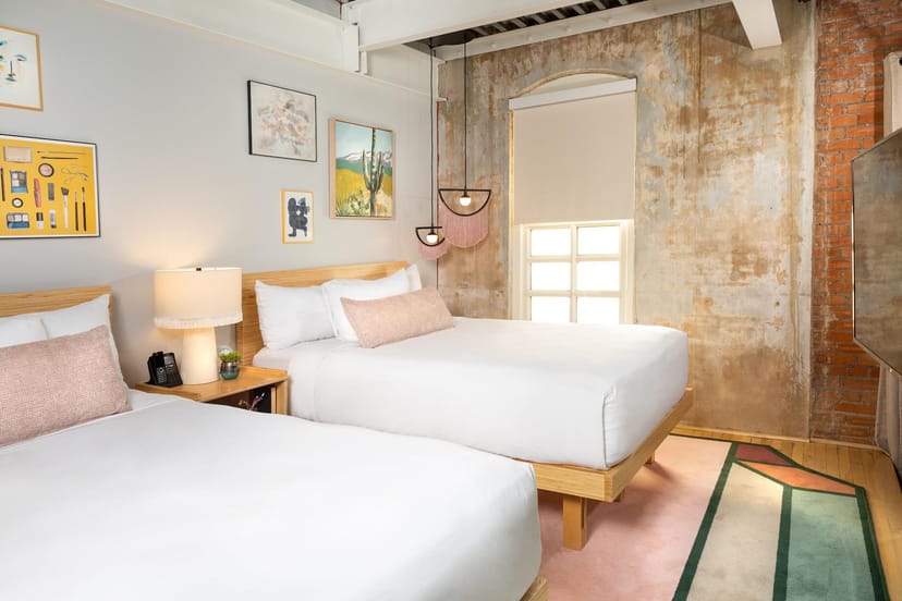 Haven Room at Canvas Dallas Hotel: modern design, two beds, event accommodations.