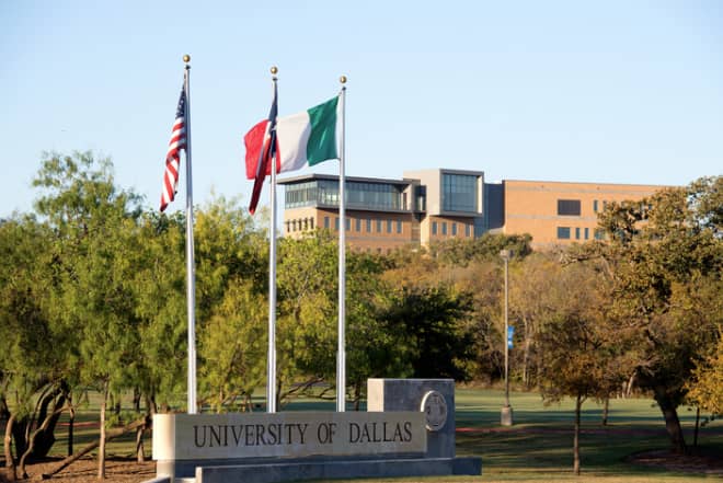 SB Hall entrance at University of Dallas, featuring flags; perfect for conferences and events.