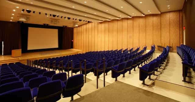 Haggar Art History Auditorium with plush blue seating for conferences and lectures.