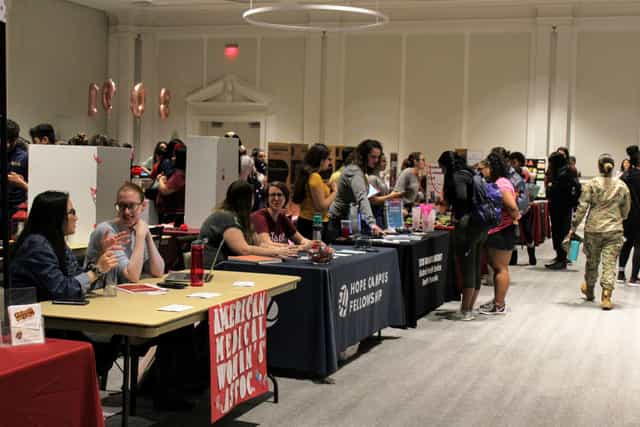 Southwest Ballroom B at Texas Woman's University, bustling expo with interactive booths.