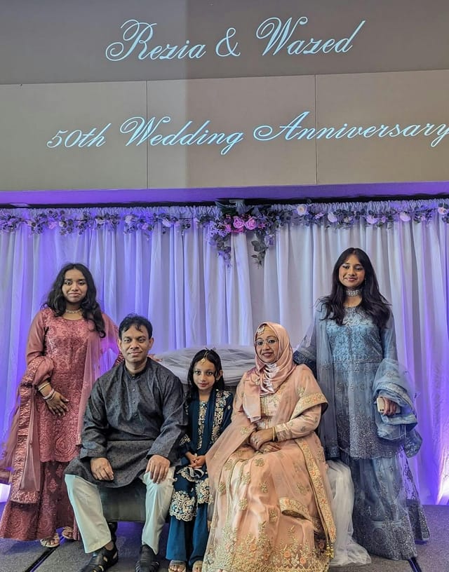 Family gathering in Grand Hall with elegant decorations for milestone celebrations.