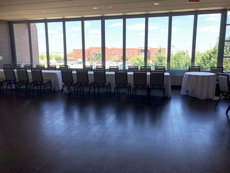Spacious Grand Hall event room with natural light, ideal for corporate meetings and receptions.