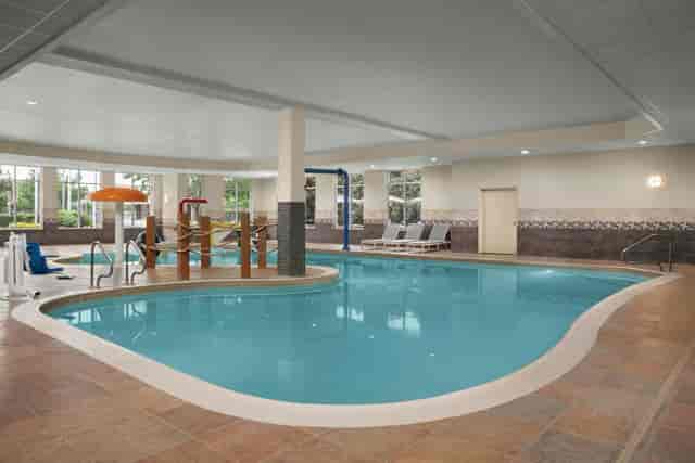 Indoor pool area with water slides at Hilton Garden Inn Fort Worth for events and gatherings.