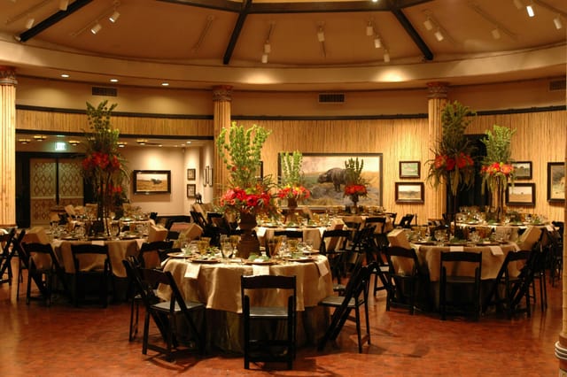 Crocodile Café event space with gold tables and vibrant florals for formal receptions.