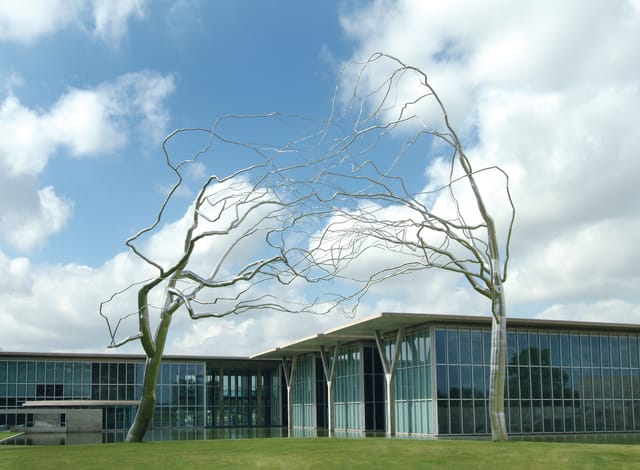 Modern outdoor venue at Fort Worth Museum with tree sculpture, ideal for receptions and events.