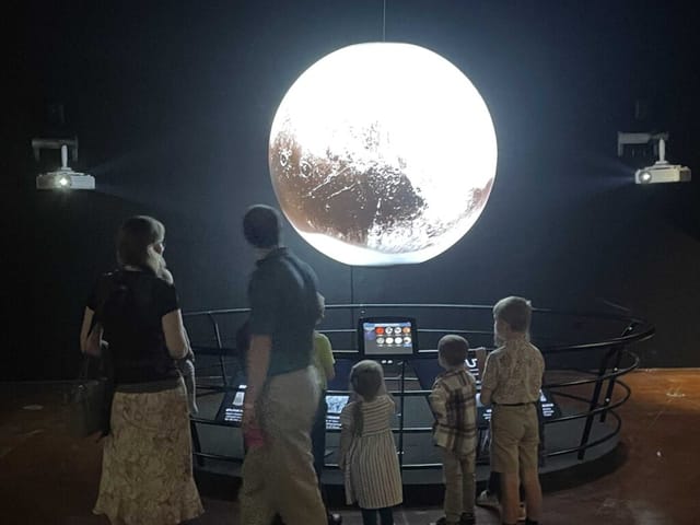 "Fort Worth Planetarium exhibit showcasing a glowing celestial body for educational family events."