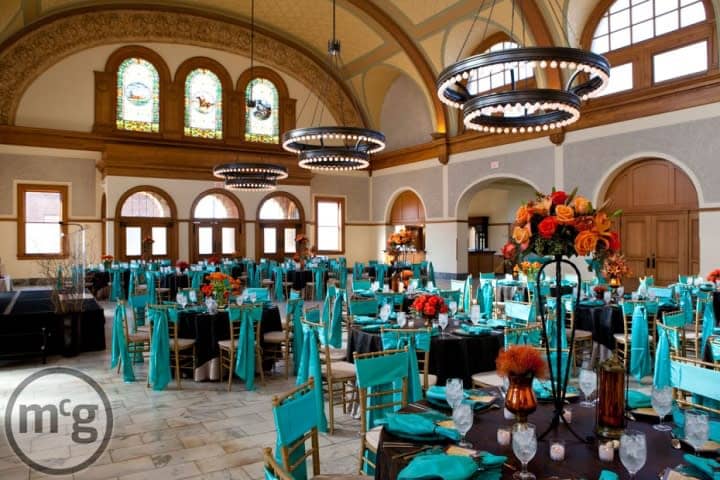 Elegant conference setup with black and turquoise linens at Ashton Depot, ideal for weddings.