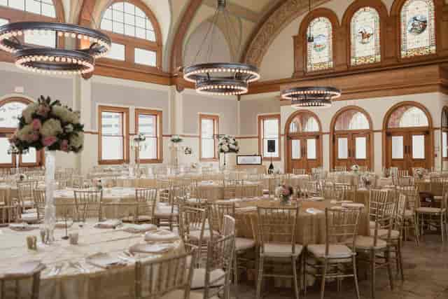 Elegant banquet hall with champagne linens, ideal for weddings and corporate events.