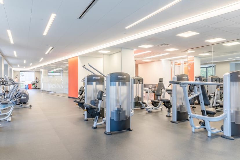 Modern fitness center in Dallas Athletic Club with exercise machines for wellness events.