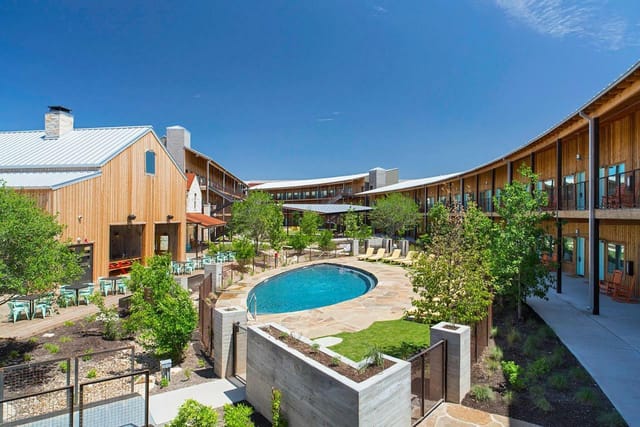 Outdoor courtyard with pool at Lone Star Court, ideal for meetings and events.