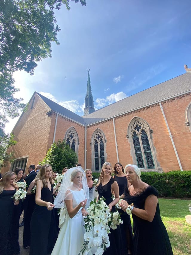 Wedding scene at Kessler Park UMC, featuring bride with bouquet and elegant bridesmaids.