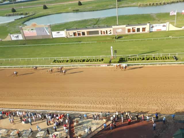 Vibrant horse racing event at Lone Star Park with expansive racetrack for gatherings.
