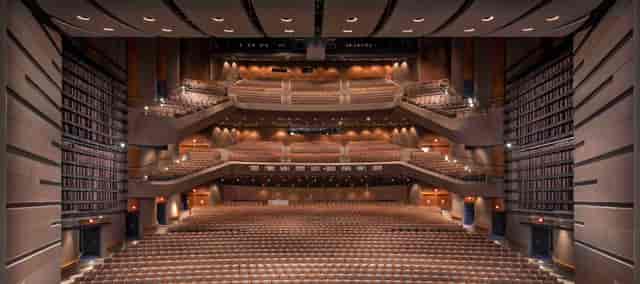 Spacious auditorium in Bass School for conferences and events, featuring tiered seating.