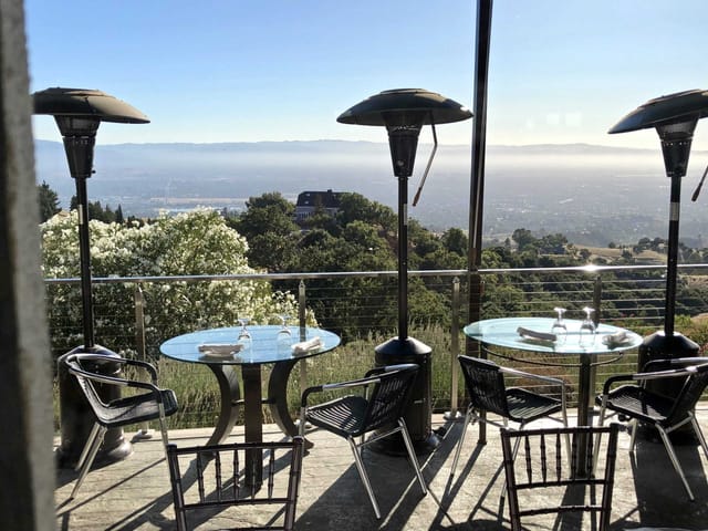 Outdoor restaurant venue with elegant glass tables, perfect for meetings and events.