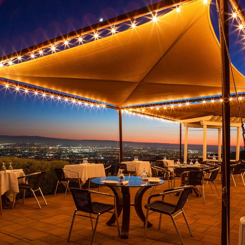 Outdoor dining at The GrandView with skyline view, perfect for evening events.