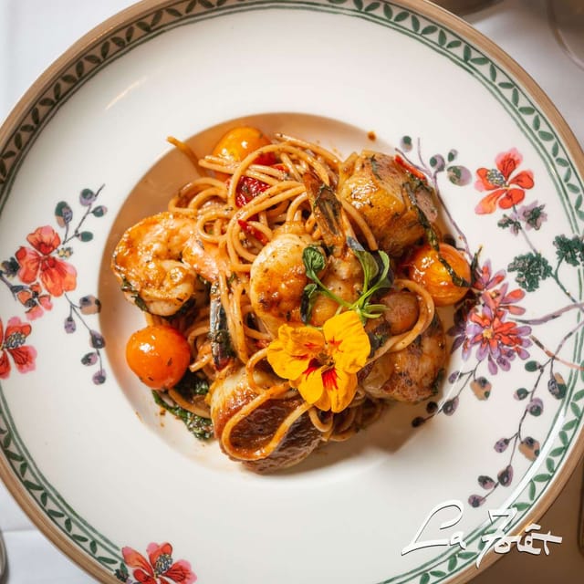 Shrimp pasta garnished with tomatoes at La Forêt for events and catering.
