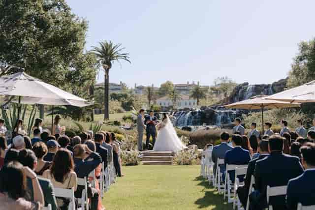 Lakeside outdoor wedding ceremony with lush greenery and floral decor in Silver Creek Valley.