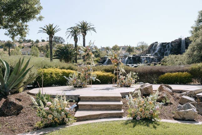 Outdoor event space at Silver Creek Valley Country Club with tiered platform and waterfall.