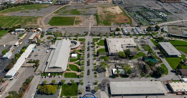 Sprawling green event venue with versatile setup for receptions and gatherings.