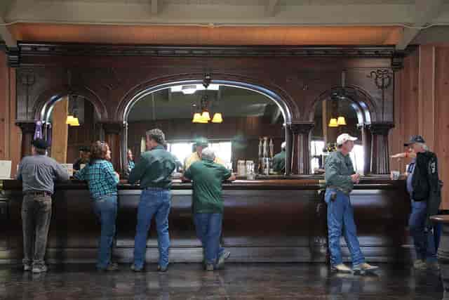 Heritage Hall rustic bar setup for casual networking events, warm lighting ambiance.