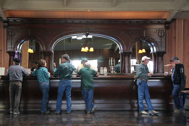 Heritage Hall rustic bar setup for casual networking events, warm lighting ambiance.
