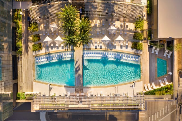 Fairmont Hotels Terrace pool area with palm trees, perfect for outdoor events and gatherings.